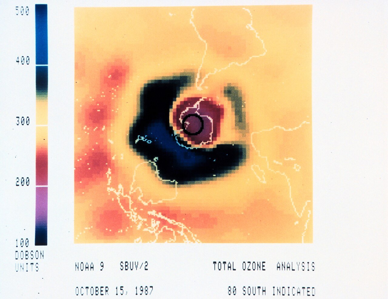 1987년 10월 15일 NOAA-9 위성 SBUV/2 관측으로 만든 남극 상공 오존 총량 지도. 가운데 남극 대륙 위가 주변보다 낮은 값의 보라·붉은색으로 나타나고, 그 둘레를 높은 값의 짙은 남색 띠가 두르며, 왼쪽에 100~500 돕슨 단위 색 막대가 있다